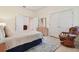 Bright bedroom featuring a patterned rug, rocking chair, and closet at 6527 Stonington Dr, Tampa, FL 33647
