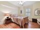 Cozy bedroom with hardwood floors, natural light, and a ceiling fan at 6527 Stonington Dr, Tampa, FL 33647