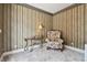 Bonus room featuring a comfortable chair, a table with a lamp, and a patterned wall at 6527 Stonington Dr, Tampa, FL 33647