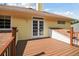 Spacious wood deck with railing and white-framed glass doors on a sunny yellow home exterior at 6527 Stonington Dr, Tampa, FL 33647