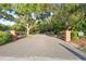 Gated entrance to a private community surrounded by mature trees and lush landscaping at 6527 Stonington Dr, Tampa, FL 33647