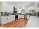 Modern kitchen with stainless steel appliances, white cabinetry, and a stylish tile backsplash at 6527 Stonington Dr, Tampa, FL 33647