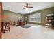 Large home office featuring tiled floors, bright windows, ceiling fan, and built-in shelving at 6527 Stonington Dr, Tampa, FL 33647