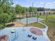 Community playground featuring a basketball court, climbing structures, and a play area on a sunny day at 6527 Stonington Dr, Tampa, FL 33647