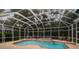 Relaxing enclosed pool area with a pool, spa, and seating for entertaining guests at 6527 Stonington Dr, Tampa, FL 33647