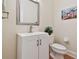 Elegant powder room featuring a modern vanity, decorative mirror, and stylish fixtures at 6527 Stonington Dr, Tampa, FL 33647