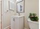 Well-lit powder room with a vanity, silver mirror and tiled floor at 6527 Stonington Dr, Tampa, FL 33647