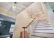 Elegant staircase showcasing hardwood steps, white railing, and decorative lighting at 6527 Stonington Dr, Tampa, FL 33647