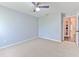 Bright bedroom with ceiling fan and neutral walls and carpet flooring at 2309 Mooney. Pl, Sun City Center, FL 33573