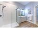 Modern bathroom with double vanity, walk-in shower, and grey wood-look flooring at 2309 Mooney. Pl, Sun City Center, FL 33573