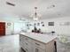 Open concept kitchen with island, stainless steel appliances, and white cabinetry at 4300 41St N St, St Petersburg, FL 33714