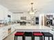Bright kitchen featuring white cabinets, granite counters, and an island with seating at 4300 41St N St, St Petersburg, FL 33714