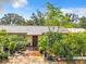 Ranch style home with brick driveway, lush landscaping, and a spacious front yard at 4300 41St N St, St Petersburg, FL 33714