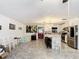 Open concept kitchen with island, stainless steel appliances, and white cabinetry at 4300 41St N St, St Petersburg, FL 33714