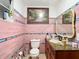 Pink tiled bathroom with vanity and toilet at 4300 41St N St, St Petersburg, FL 33714