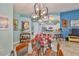 Open concept dining room showcasing a glass dining table and a view into the kitchen and living areas at 2447 Nantucket Harbor Loop # 112, Sun City Center, FL 33573