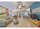Bright living room featuring a comfy couch and large TV at 2447 Nantucket Harbor Loop # 112, Sun City Center, FL 33573