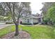 House exterior with American flag and manicured lawn at 2447 Nantucket Harbor Loop # 112, Sun City Center, FL 33573