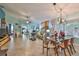 Open concept dining area with glass table and modern chairs at 2447 Nantucket Harbor Loop # 112, Sun City Center, FL 33573