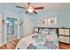 Bedroom with hardwood floors, a view of the bathroom, and ample closet space at 2447 Nantucket Harbor Loop # 112, Sun City Center, FL 33573