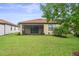 Screened patio and spacious backyard with lush green grass at 5115 Tobermory Way, Bradenton, FL 34211