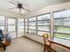 Bright sunroom with a ceiling fan, comfy seating, and views of the surrounding area at 35801 Verda Dr, Zephyrhills, FL 33541