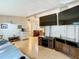 Spacious living room with large screen TVs and hardwood floors at 35801 Verda Dr, Zephyrhills, FL 33541