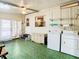 Spacious laundry room with ample storage and green flooring at 35801 Verda Dr, Zephyrhills, FL 33541