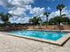Community swimming pool with lounge chairs and patio furniture at 35801 Verda Dr, Zephyrhills, FL 33541