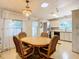 Bright dining area with kitchen and sunroom access at 35801 Verda Dr, Zephyrhills, FL 33541