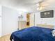 Main bedroom with a large TV and ample dresser space at 35801 Verda Dr, Zephyrhills, FL 33541