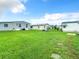 Spacious grassy backyard with multiple mobile homes visible at 35801 Verda Dr, Zephyrhills, FL 33541