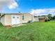 Tan mobile home with double doors and AC unit at 35801 Verda Dr, Zephyrhills, FL 33541