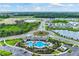 Aerial view of community pool, clubhouse, and surrounding homes at 5809 Silver Feather Way, Palmetto, FL 34221