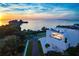 Waterfront property showcasing sunset views and modern architecture at 100 Shore Dr, Tarpon Springs, FL 34689