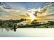 Relaxing pool with sunset view overlooking the water at 100 Shore Dr, Tarpon Springs, FL 34689