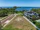 Aerial view of waterfront property with vacant lot at 100 Shore Dr, Tarpon Springs, FL 34689
