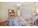 Bedroom with floral bedding, built-in shelving, and wood floors at 6527 Stonington Dr, Tampa, FL 33647