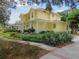 Two-story yellow house with landscaping and walkway at 6527 Stonington Dr, Tampa, FL 33647