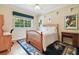 Bright bedroom with wood floors, built-in shelves, and a comfortable bed at 6527 Stonington Dr, Tampa, FL 33647