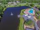 Resort-style pool and clubhouse near a lake at 6527 Stonington Dr, Tampa, FL 33647