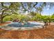 Playground with play structures under large oak trees at 6527 Stonington Dr, Tampa, FL 33647