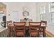 Elegant dining room featuring a wood table, chandelier, and decorative clock at 6527 Stonington Dr, Tampa, FL 33647
