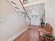Elegant entryway with hardwood floors, staircase, and a wooden bench at 6527 Stonington Dr, Tampa, FL 33647