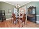 Formal dining room with hardwood floors, chandelier, and antique secretary at 6527 Stonington Dr, Tampa, FL 33647