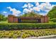 Brick entrance sign for Stonington community with yellow flowers at 6527 Stonington Dr, Tampa, FL 33647