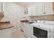 Well-equipped laundry room with granite countertop, washer and dryer at 6527 Stonington Dr, Tampa, FL 33647