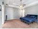 Main bedroom with king-size bed, carpet flooring, and ceiling fan at 2816 Rolling Acres Pl, Valrico, FL 33596