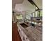 Modern kitchen island with granite countertop and farmhouse sink at 12384 Creek Edge Dr, Riverview, FL 33579