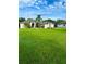 House exterior with lush green lawn and palm trees at 12384 Creek Edge Dr, Riverview, FL 33579